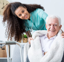 smiling doctor caring about patient at home